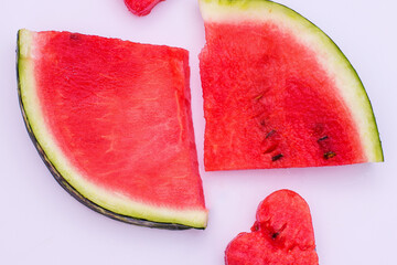 Juicy bright red watermelon on a white isolated background, watermelon in the shape of a heart