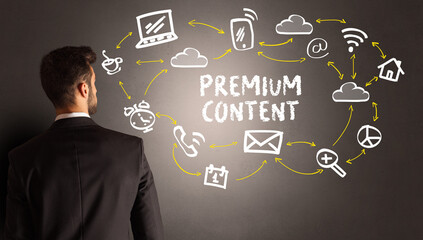 businessman drawing social media icons with PREMIUM CONTENT inscription, new media concept