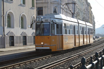Fototapeta na wymiar Yellow and white tram through the streets of Budapest