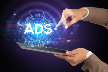 Close-up of a touchscreen with ADS abbreviation, modern technology concept
