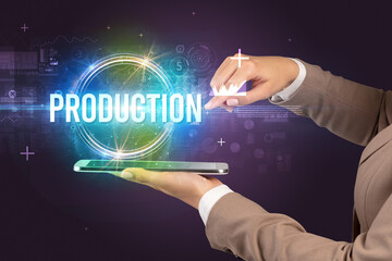 Close-up of a touchscreen with PRODUCTION inscription, new technology concept