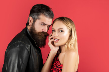 Vogue Style. Fashion couple looking at the camera Hipsters love on red.