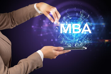 Close-up of a touchscreen with MBA abbreviation, modern technology concept