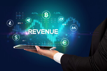 Close-up of a touchscreen with REVENUE inscription, business opportunity concept