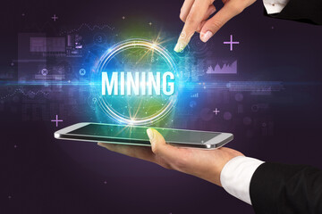 Close-up of a touchscreen with MINING inscription, new technology concept