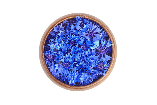 Fresh cornflower petals in wooden bowl isolated on white background