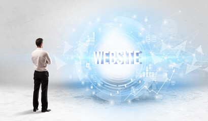 Rear view of a businessman standing in front of WEBSITE inscription, modern technology concept