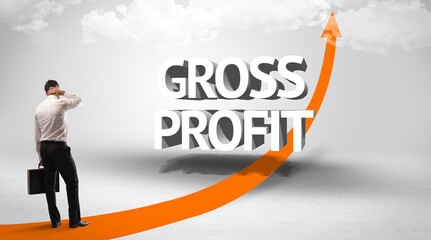 Fototapeta premium Rear view of a businessman standing in front of GROSS PROFIT inscription, successful business concept