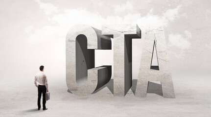 Rear view of a businessman standing in front of CTA abbreviation, attention making concept