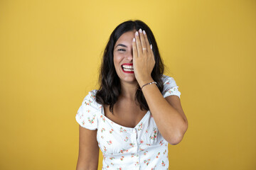covering one eye with hand, confident smile on face and surprise emotion.