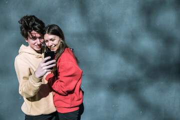two young friends using mobile smart phones outdoors, copy space, youth tech addicts, social media concept, millennials having fun, social media advertising, friend campaigns, boyfriend couples with 