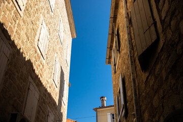 Fototapeta na wymiar Narrow street in old european town budva, montenegro, stone houses
