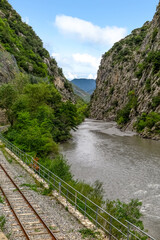 Fototapeta na wymiar Tineé River between cliffs with railway road beside it, Provence-Alpes-Côte d'Azur region, Alpes de Haute Provence, France