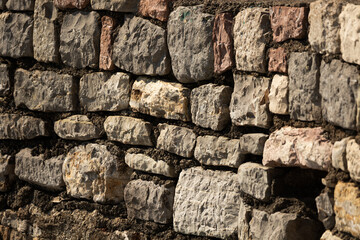 Texture of stones of the protective wall of the old town of budva