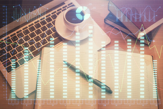Stock market graph and top view computer on the table background. Multi exposure. Concept of financial education. © peshkova