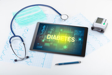 Tablet pc and medical stuff with DIABETES inscription, prevention concept