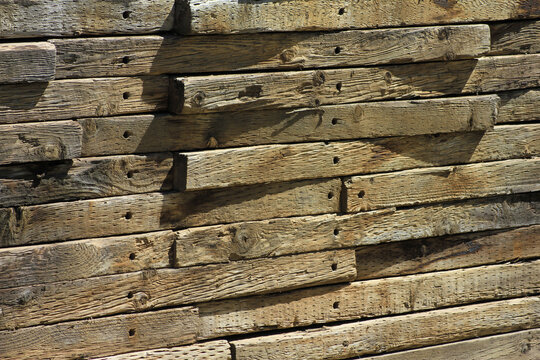 Stacked wood railroad tie retaining wall background