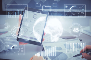 Double exposure of man's hands holding and using a digital device and forex graph drawing. Financial market concept.