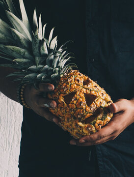 Young Man Holds A Halloween Pineapple