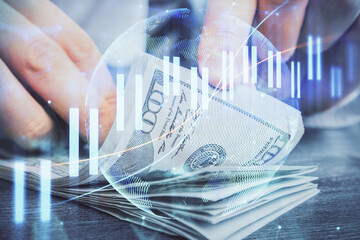 Multi exposure of forex graph drawing hologram and USA dollars bills and man hands. Technical Analysis concept.