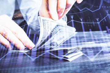 Multi exposure of forex graph drawing hologram and USA dollars bills and man hands. Technical...