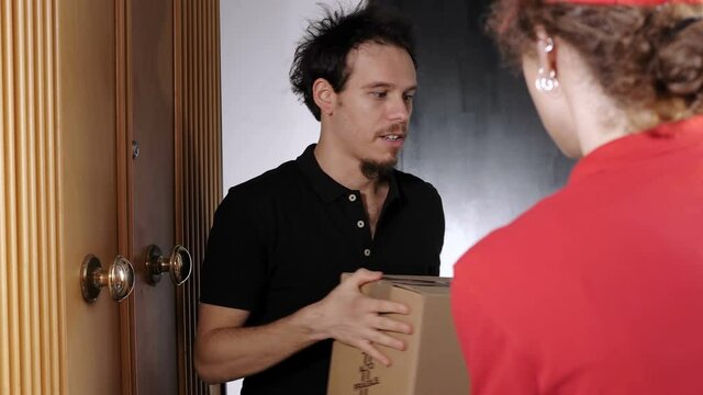 shopping online -young man taking a package that the woman courier delivers