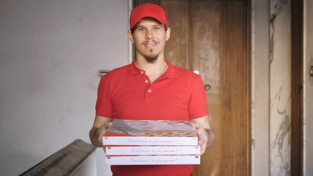  young confident rider delivering pizzas looking at camera smiling