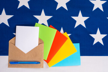 Multicolored letters on the background of the stars of the American flag. Correspondence with Americans. US post. Writing paper with space for text on the background of the flag of the USA.