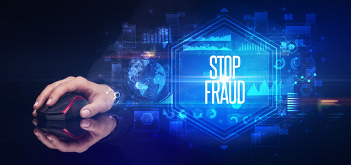 hand holding wireless peripheral with STOP FRAUD inscription, cyber security concept