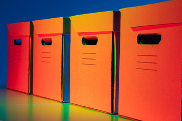 Four close-up document storage boxes. Storage of paper archives. Cardboard boxes with slits for hands. Crates with handles for easy transport.