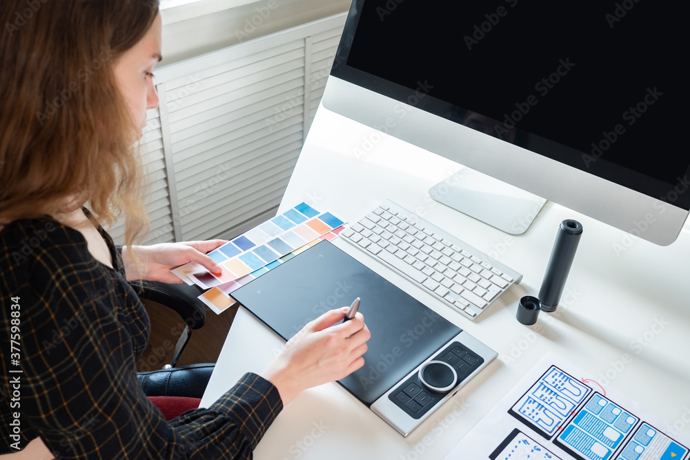 Aufkleber the mobile app designer works with a graphic tablet. working project of the graphic designer. drawin