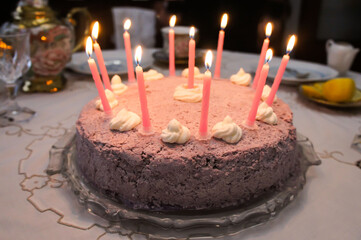 pink birthday cake with candles