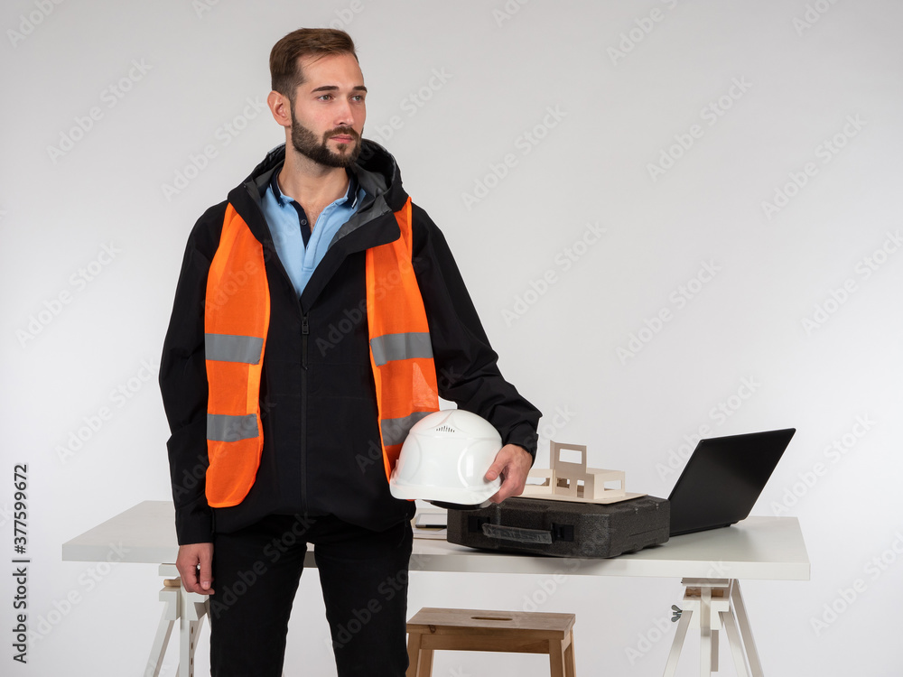 Poster architect on the background of the layout of the house under construction. portrait of a constructio