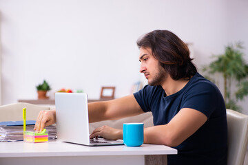 Young man employee working from house