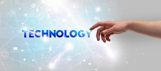 Hand pointing at TECHNOLOGY inscription, modern technology concept