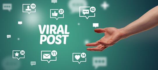 Close-Up of cropped hand pointing at VIRAL POST inscription, social networking concept