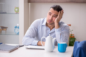 Young male employee working from the house