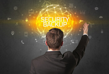 Rear view of a businessman with SECURITY BACKUP inscription, online security concept