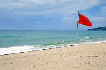 Red flag on the beach, no swimming sign on the beach of Thailand