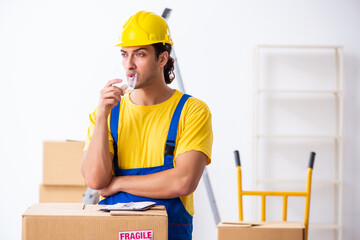 Young male professional mover doing home relocation