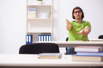 Young male student in the classroom