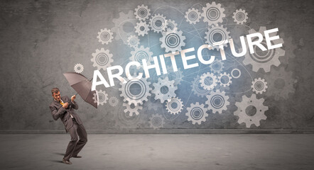 Fototapeta premium Businessman defending with umbrella from ARCHITECTURE inscription, technology concept