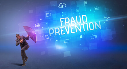 Businessman defending with umbrella from cyber attack and FRAUD PREVENTION inscription, online security concept