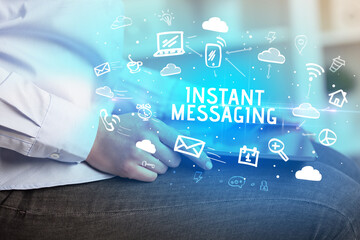 Close-up Of A Person Using Social Networking with INSTANT MESSAGING inscription