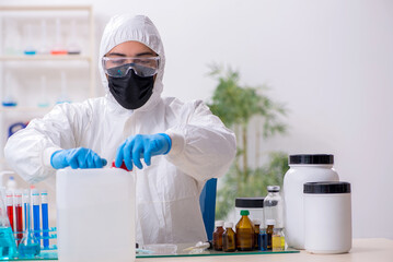 Young male chemist working in medicine lab