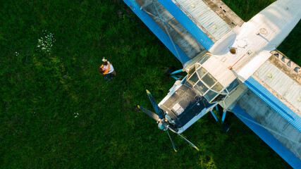 beautiful happy couple in love standing near the old planes hugging
