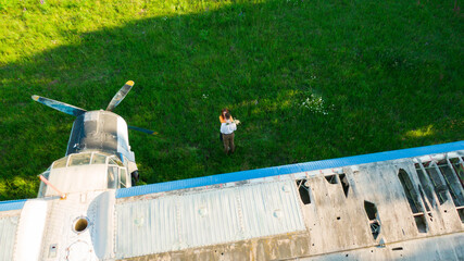 beautiful happy couple in love standing near the old planes hugging