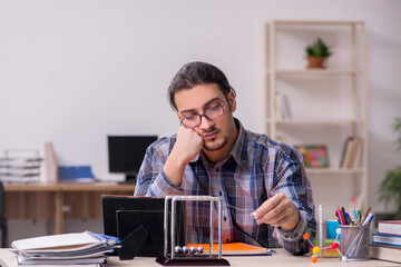 Young male student sitting in the classroom