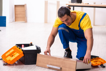 Young male carpenter working indoors