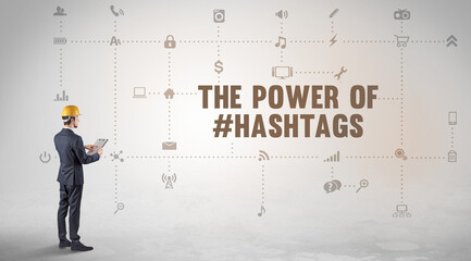 Engineer working on a new social media platform with THE POWER OF #HASHTAGS inscription concept